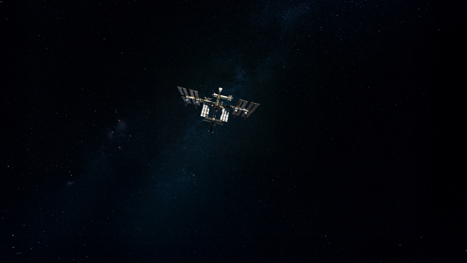 International Space Station orbiting in dark starry space, with solar panels extended